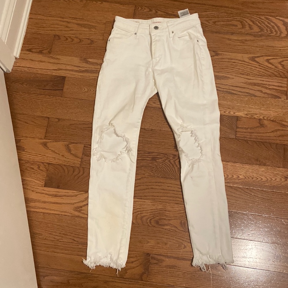 White Levi’s jeans with rips in the knee. 721 high rise